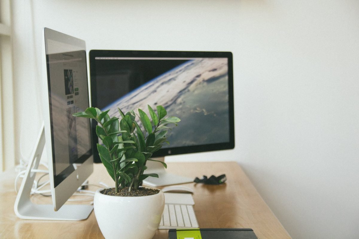 silver imac on brown table inside room